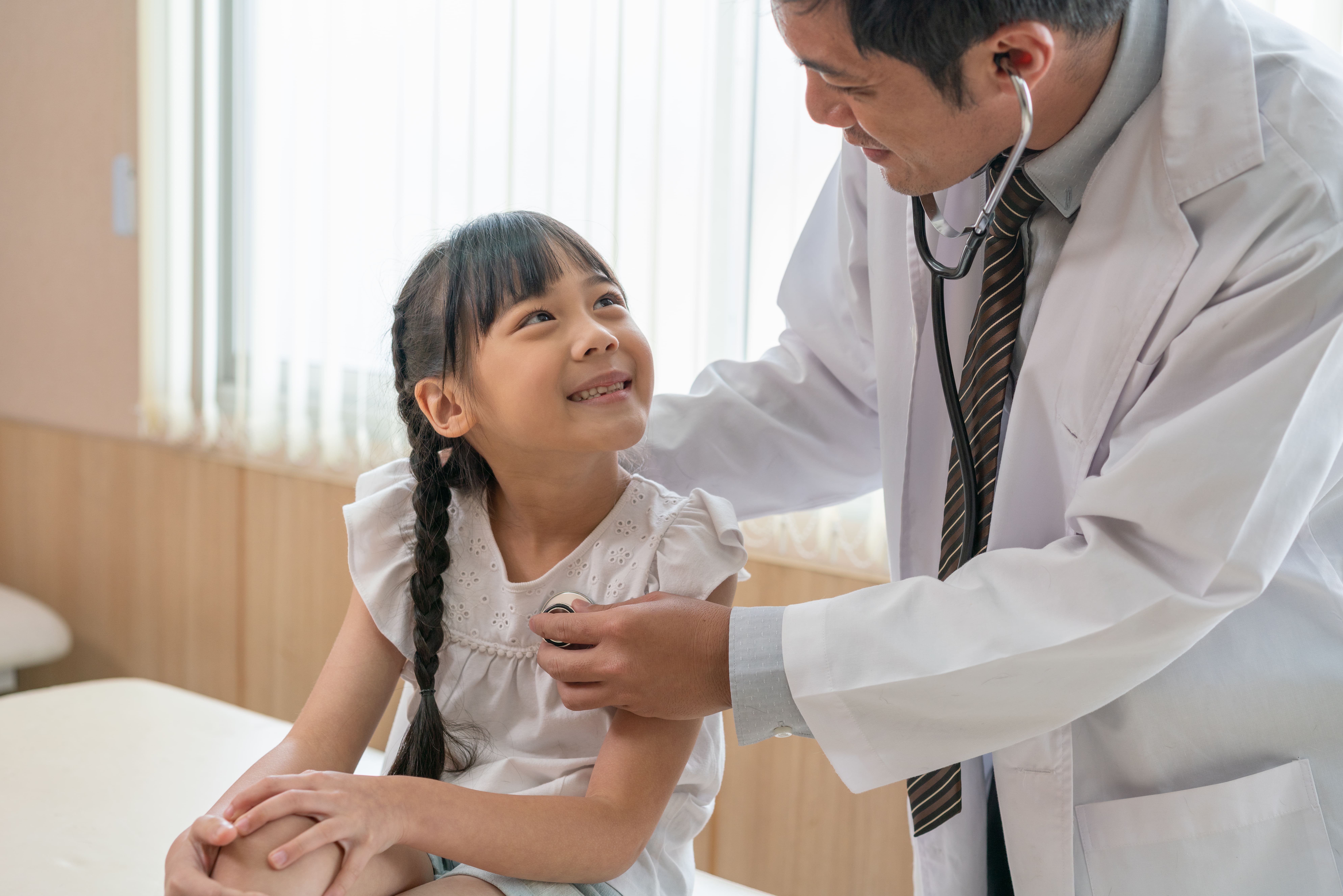 doctor-using-stethoscope-examine-little-girl-patient-hospital
