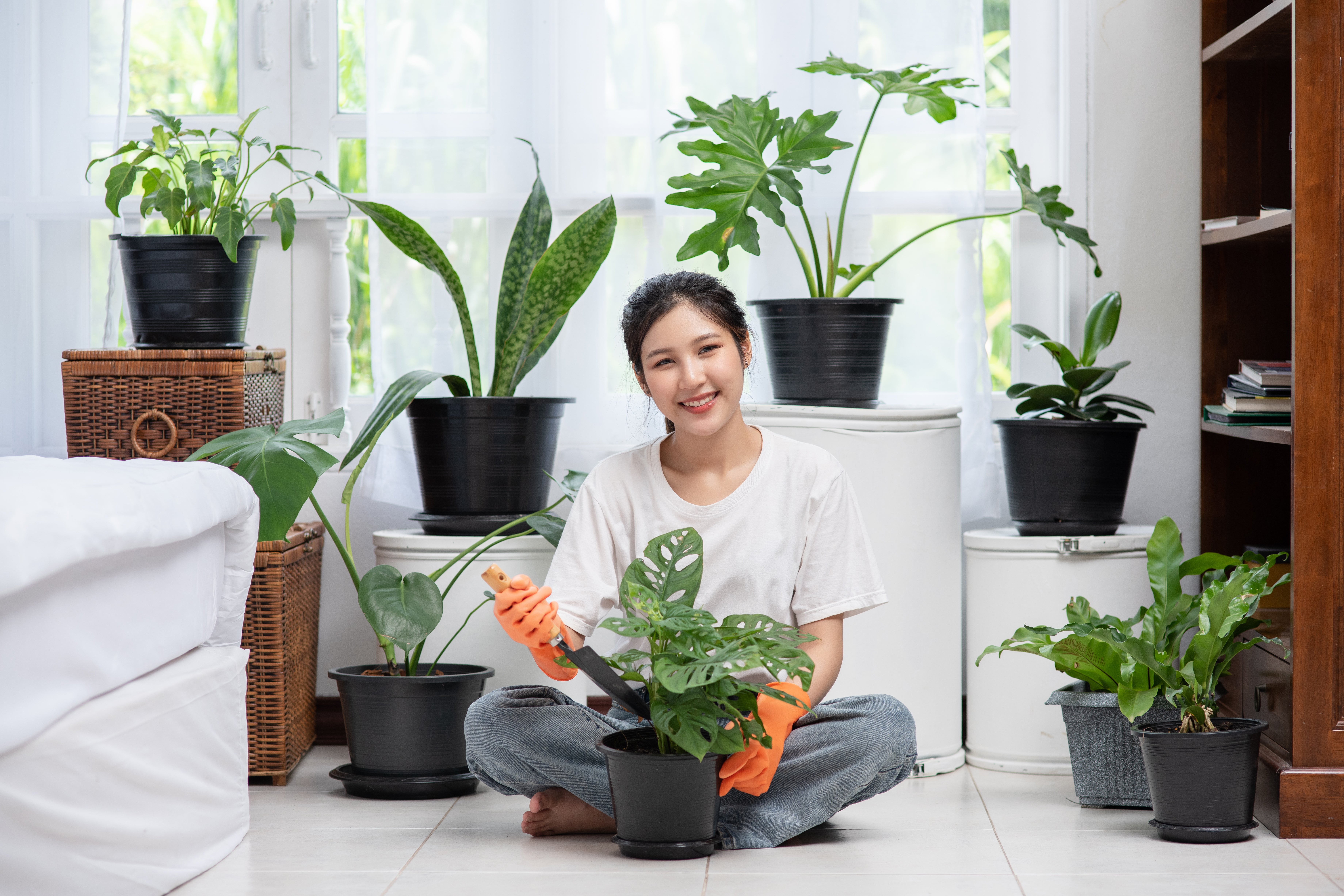 woman-wore-orange-gloves-planted-trees-house
