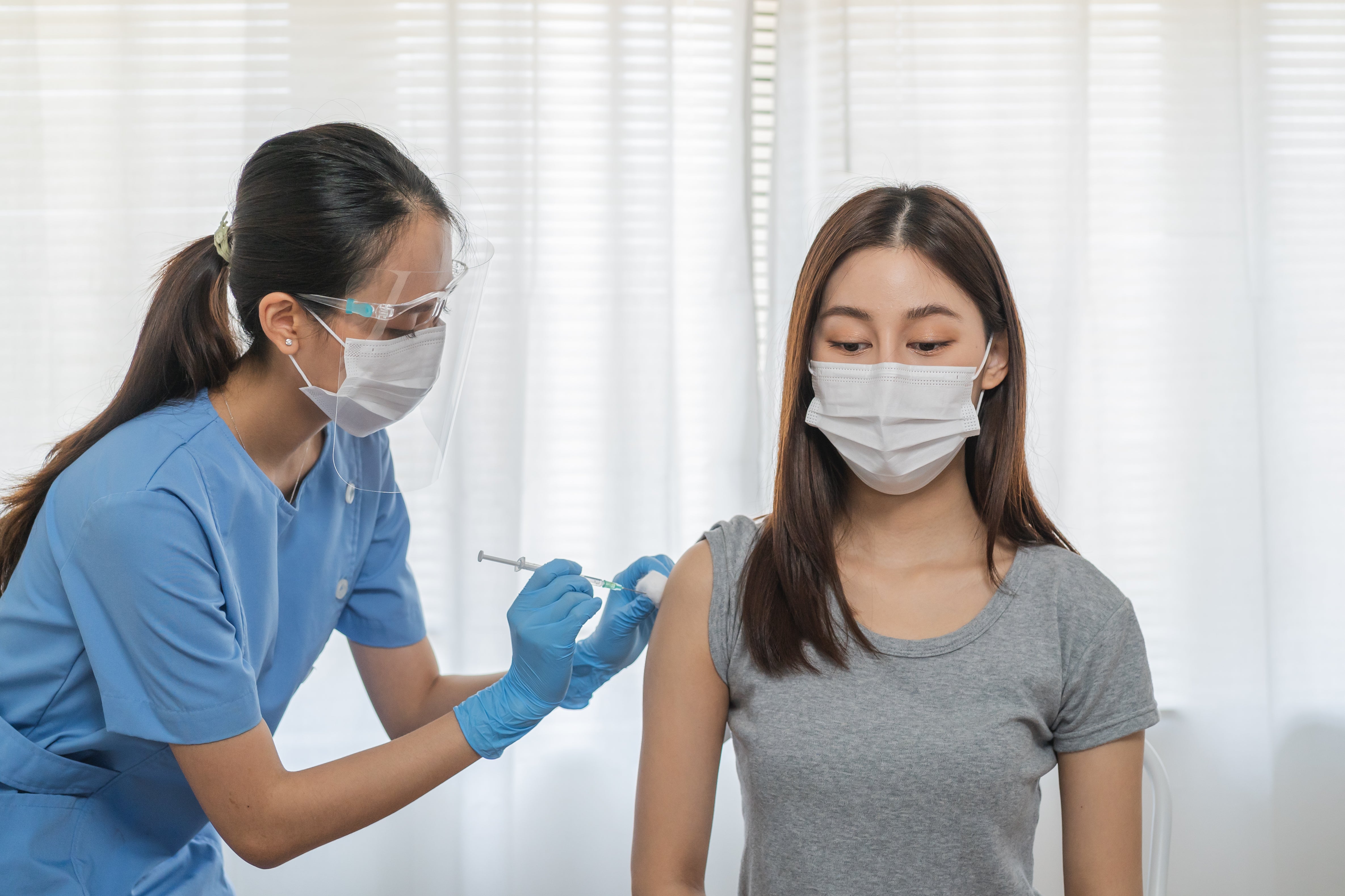 covid-19-coronavirus-hand-young-woman-nurse-doctor-giving-syringe-vaccine-inject-shot-asian-arm-s-patient-vaccination-immunization-disease-prevention-against-flu-virus-pandemic-concept