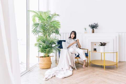 oung-pretty-woman-smile-sits-chair-modern-living-area-with-green-plant-relaxing-drinking-cup-hot-coffee-enjoying-quiet-time-indoor-environment-cozy-home